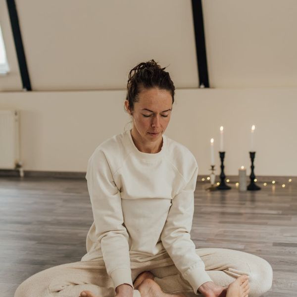 Person sitting in a meditative yoga pose, radiating a sense of peace.